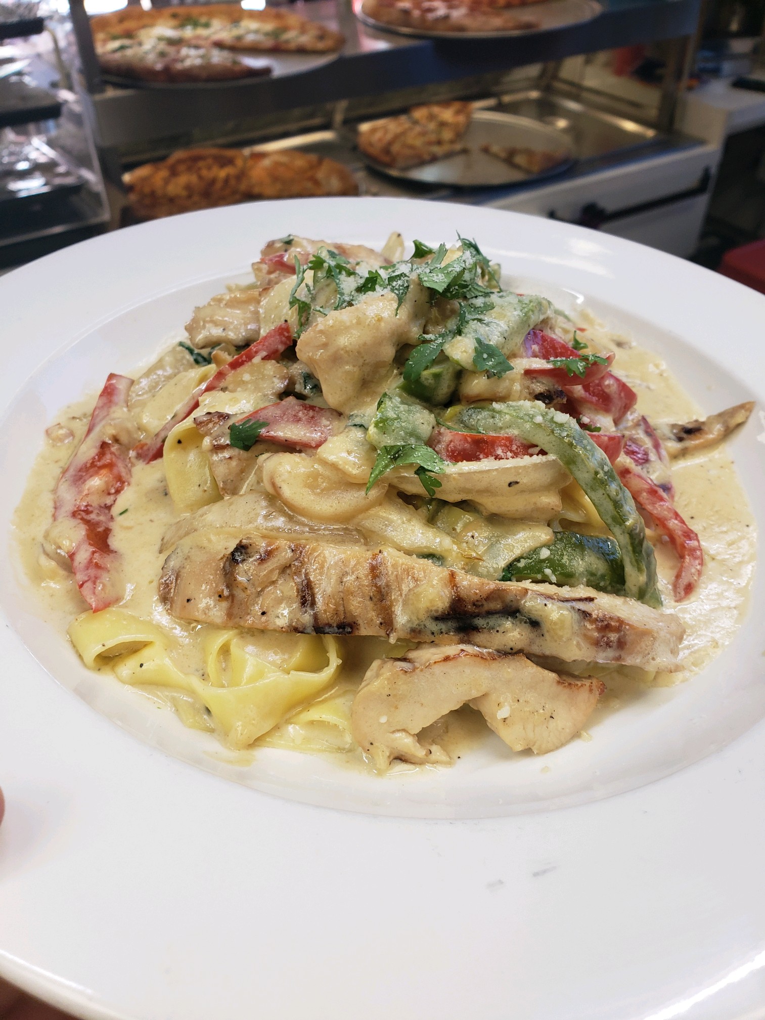 Fettuccine with grilled chicken and peppers in cream sauce